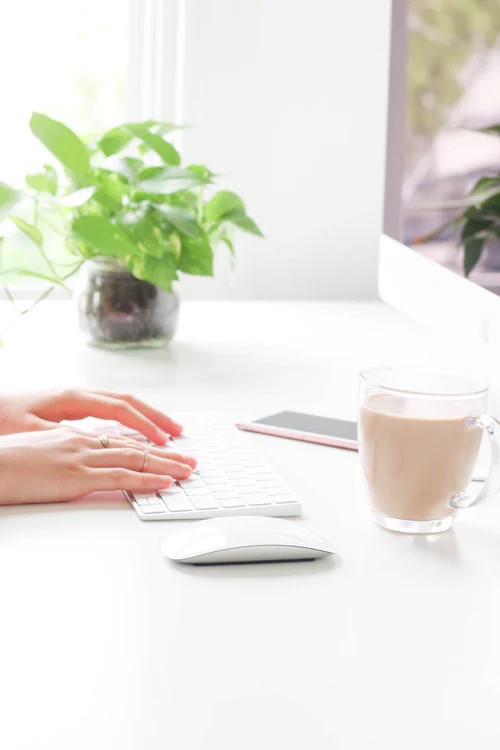 Woman Typing on Keyboard at Innovative Content Creation.